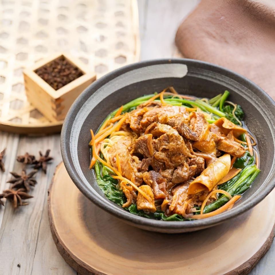 Braised pork and mushroom noodles with green vegetables in a dark bowl on a wooden table.
